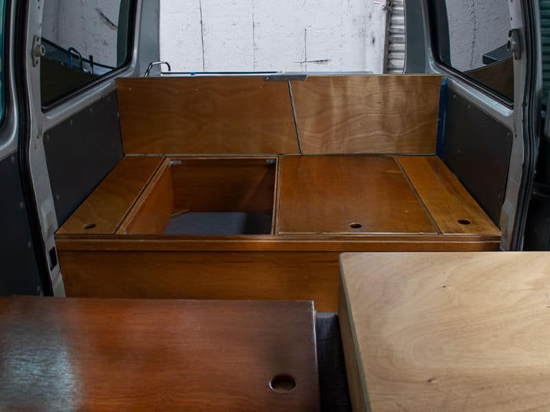 Escape Rentals NZ Our Campervan interior 10 - Self-contained campervan interior: Smart design — hidden storage underneath the bed.