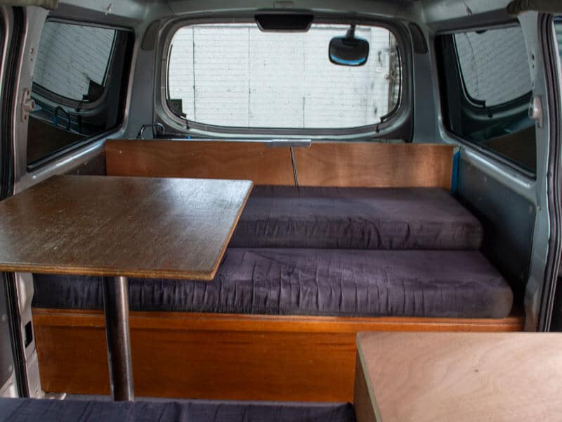 Escape Rentals NZ Our Campervan interior 11 - Self-contained campervan interior: Smart design — convert your bed to a dining area.