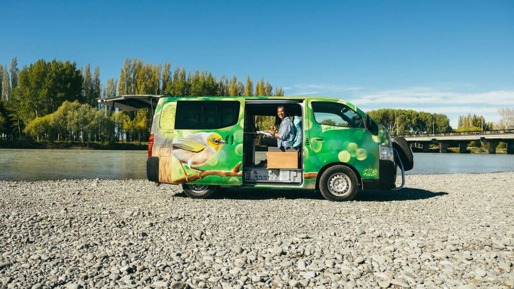 Escape Rentals NZ An Escape campervan parked up on the coast, fully equipped for life on the road.