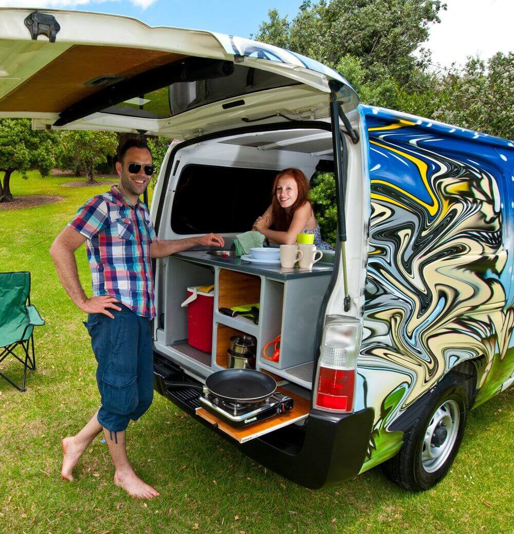 Campervan kitchen with gas cooker, chilly bin and cooking utensils